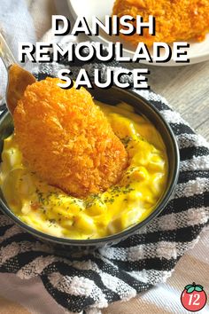 a close up of a bowl of food on a towel with the words danish remoulade sauce