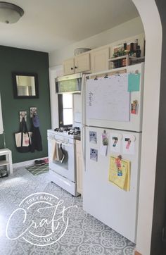 a white refrigerator freezer sitting inside of a kitchen next to a stove top oven