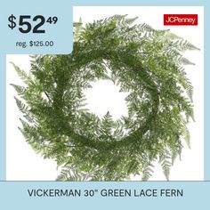 a green wreath with the words $ 52 99 reg $ 250 00 on it and an image of a fern