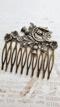 Bronze Hair Comb ♥ Ornately Beautiful ♥ Flower Hair Comb ☻Color: ~ Silver ☻Link to More Hair Accessories: https://www.etsy.com/shop/FashionCrashJewelry?ref=profile_header&search_query=hair+accessories ☻Link to The ENTIRE SHOP: https://www.etsy.com/shop/FashionCrashJewelry?ref=shopsection_shophome_leftnav&ga_search_query=crystal%2Bnecklace Our Motto ~ Happy Customers Are Awesome Let us know of any problems or concerns with purchases. 5star reviews and positive comments are greatly appreciated, th Jeweled Hair Comb, Thistle Plant, Antique Hair Combs, Decorative Hair Combs, Bronze Hair, Bun Holder, Thistle Flower, Vintage Hair Combs, Positive Comments