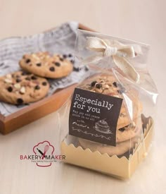 two cookies wrapped in cellophane and tied with a bow are sitting next to each other on a table