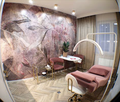 a mirror view of a room with two chairs and a table in front of it