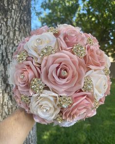 a bridal bouquet made with pink roses and diapered gold sequins