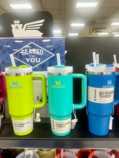 several different colored coffee mugs are on display