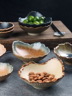 several bowls with nuts in them on a table