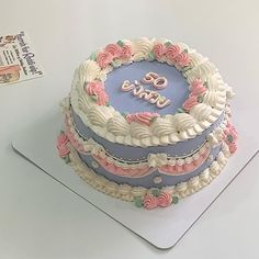 there is a cake that has been decorated with pink and blue icing on it