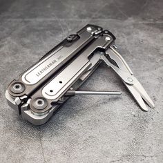 a multi - tool is laying on the floor with several tools attached to it