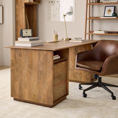 an office desk with a chair and bookshelf in front of it on carpeted floor