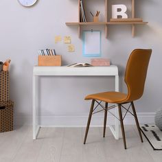 a white desk with a chair and clock on the wall