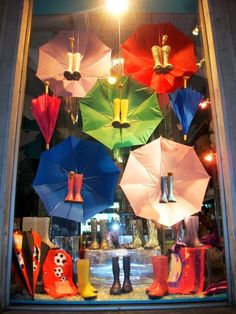 there are many colorful umbrellas in the window