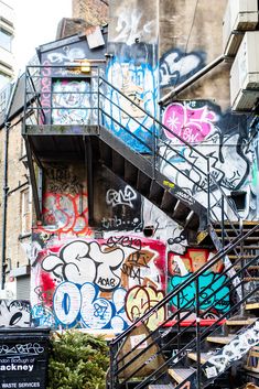 the stairs are covered in graffiti and have been painted with various colors, shapes and sizes