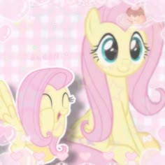 two little ponys sitting next to each other on a checkered tablecloth background