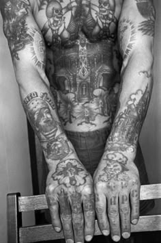 a man with many tattoos on his arms