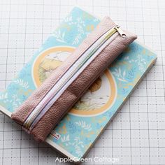 a zippered pouch sitting on top of a piece of paper