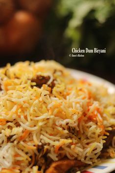 chicken dum biriyani on a plate with carrots in the background