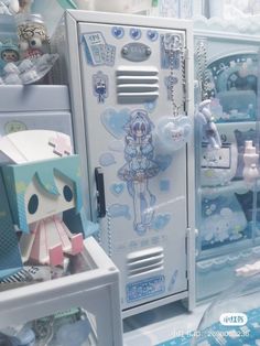 a white refrigerator sitting inside of a kitchen next to a window filled with dolls and other items