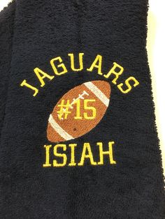 a black towel with an orange and white football on it that says jaquars 15 hai