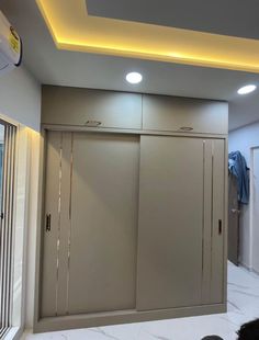 an empty room with some closets and lights on the ceiling in it's corner