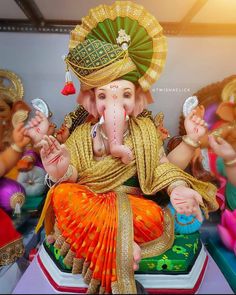 there is a statue of the god ganesh in front of many other people, including men and women