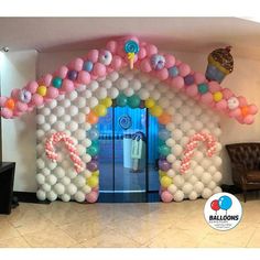 balloon arch in the shape of a house with balloons on it's front door