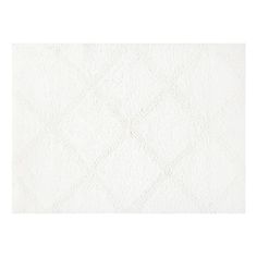 a white rug with diamond shapes on it