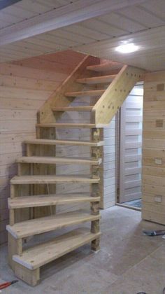 a staircase made out of wooden planks in a garage