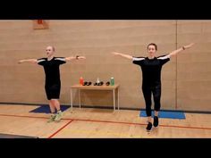 two people standing on yoga mats with their arms outstretched