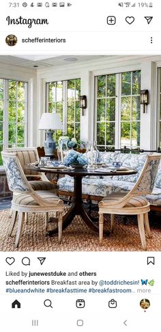 an instagramted photo of a dining room table with blue and white upholstered chairs