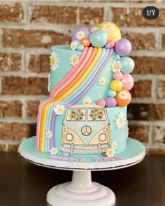 a cake with a vw bus and rainbow decorations