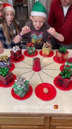 a group of people standing around a table with presents