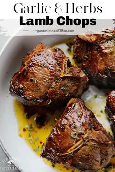 garlic and herbs lamb chops in a white bowl with lemon sauce on the side