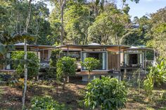 the house is surrounded by trees and plants