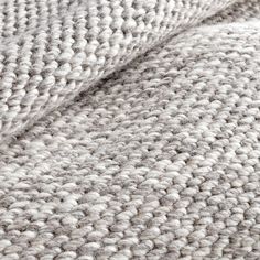 the texture of a blanket is shown in grey and white