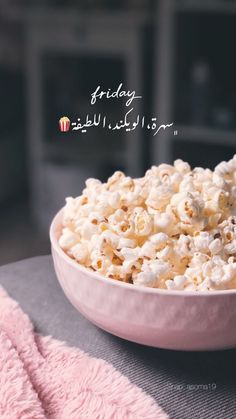 a bowl filled with popcorn sitting on top of a table