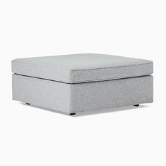 a light gray ottoman sitting on top of a white floor