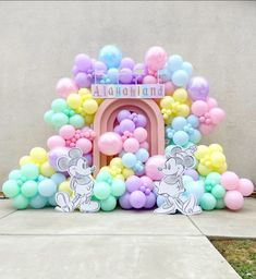 a balloon arch with mickey mouse balloons on it