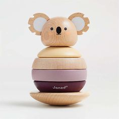 a wooden toy with a koala on it's head sitting on top of another toy