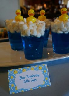 blue raspberry jello cups with rubber ducks on them and marshmallows in the middle