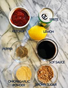 the ingredients to make an apple cider recipe on a marble countertop with lemons, ketchup, pepper, and sugar