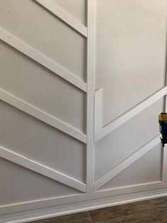 a blue and yellow fire hydrant sitting next to a white door