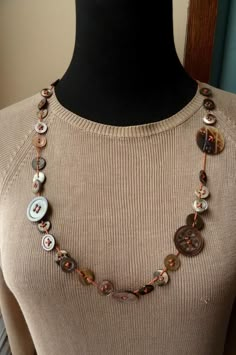 a woman wearing a necklace with buttons on it