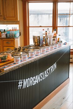 a kitchen counter with jars on it that says morganslatstrin and is next to a window