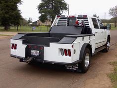 a white truck is parked on the side of the road