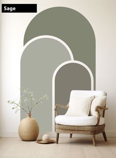 a white chair sitting in front of a green wall