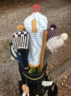 the golf bag has several knitted items in it