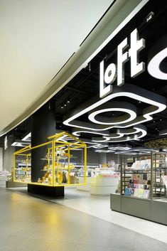 the interior of a store with yellow and black lighting