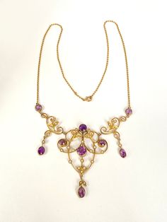 This extremely beautiful antique Lavalier features 9 lavender coloured amethysts and 38 creamy seed pearls arranged in a pretty floral design. Such a magnificent and regal piece could only have been created in the early Edwardian era; every aspect is stunningly produced; the colour combination, the settings and the wide arrangement of gems, giving great jewellery coverage to the décolletage. This is a very special antique pendant. It is marked for 9ct Gold on its 15 inch chain clasp, and it meas Antique Purple Necklace For Wedding, Victorian Hallmarked Purple Necklace, Victorian Style Hallmarked Purple Necklaces, Big Diamond, Antique Pendant, Medieval Jewelry, Lavender Color, Seed Pearl, Diamond Jewelry