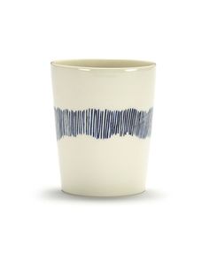 a white cup with blue stripes on the outside and inside, sitting in front of a white background