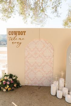 a wedding ceremony setup with candles and flowers in front of a cowboy theme sign that says, there is no way