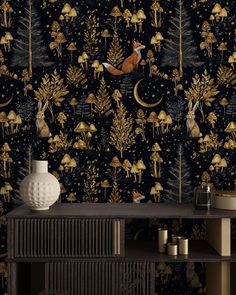 the wallpaper is decorated with gold and black trees, mushrooms, and deers